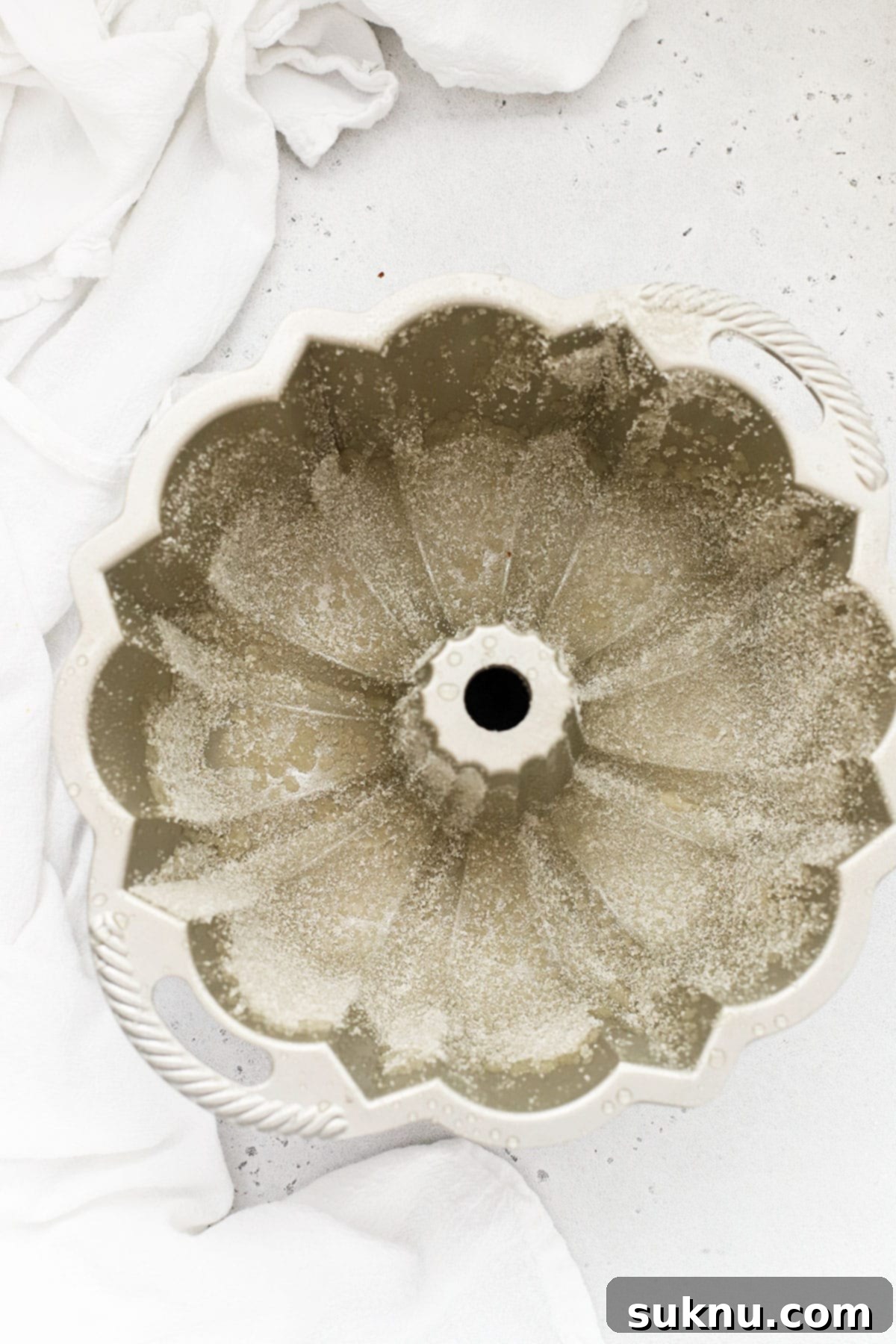 Zesty Gluten-Free Lemon Bundt Cake 6 A perfectly greased and sugared bundt pan, ready for gluten-free lemon cake batter.