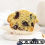 gluten-free blueberry muffin cut in half to reveal a fluffy texture