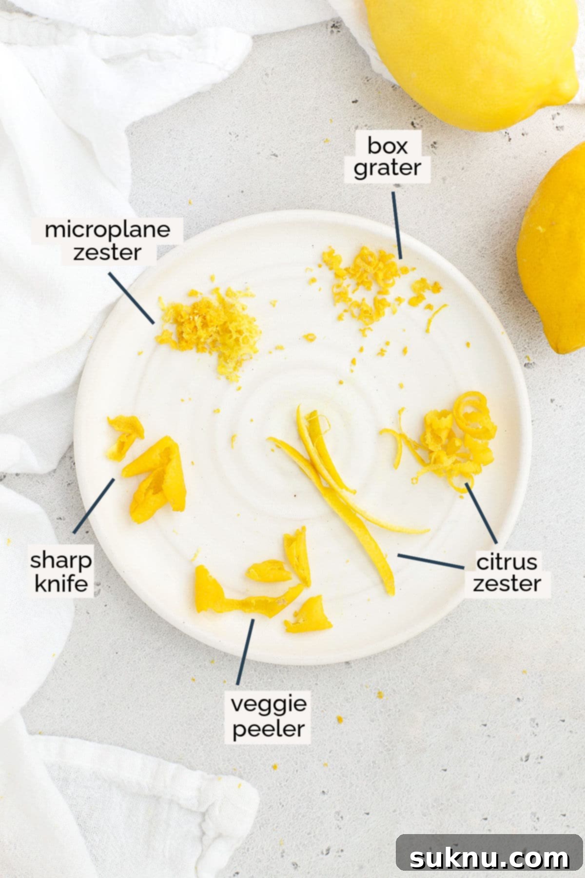 Six different sizes of lemon zest on a white plate, highlighting various methods of zesting