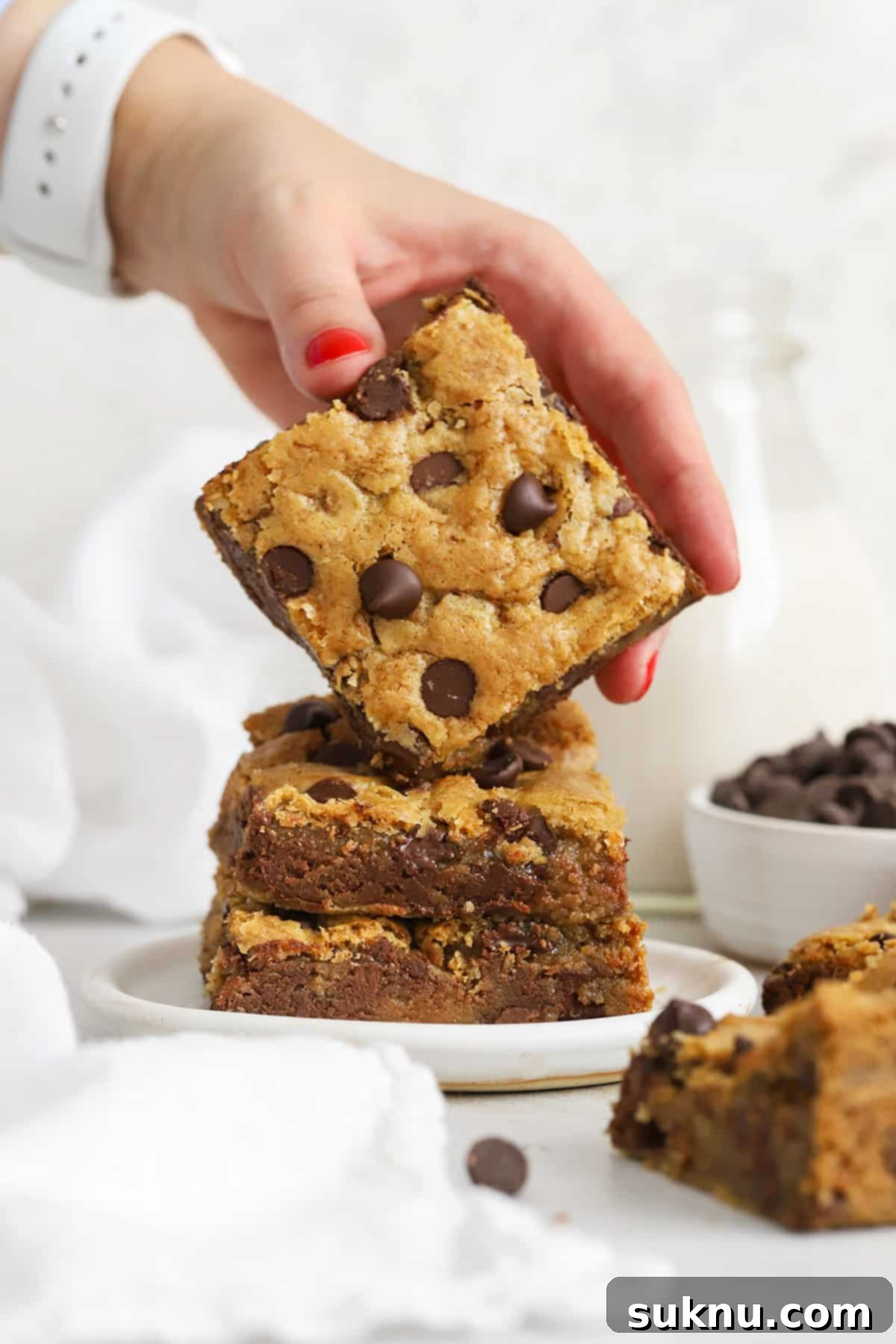 Ultimate Gluten-Free Chocolate Chip Cookie Bars 2 Stacked gluten-free chocolate chip blondie bars, showcasing their thick and chewy texture.