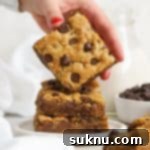 Ultimate Gluten-Free Chocolate Chip Cookie Bars 11 Stacked gluten-free chocolate chip blondie bars, showcasing their thick and chewy texture.