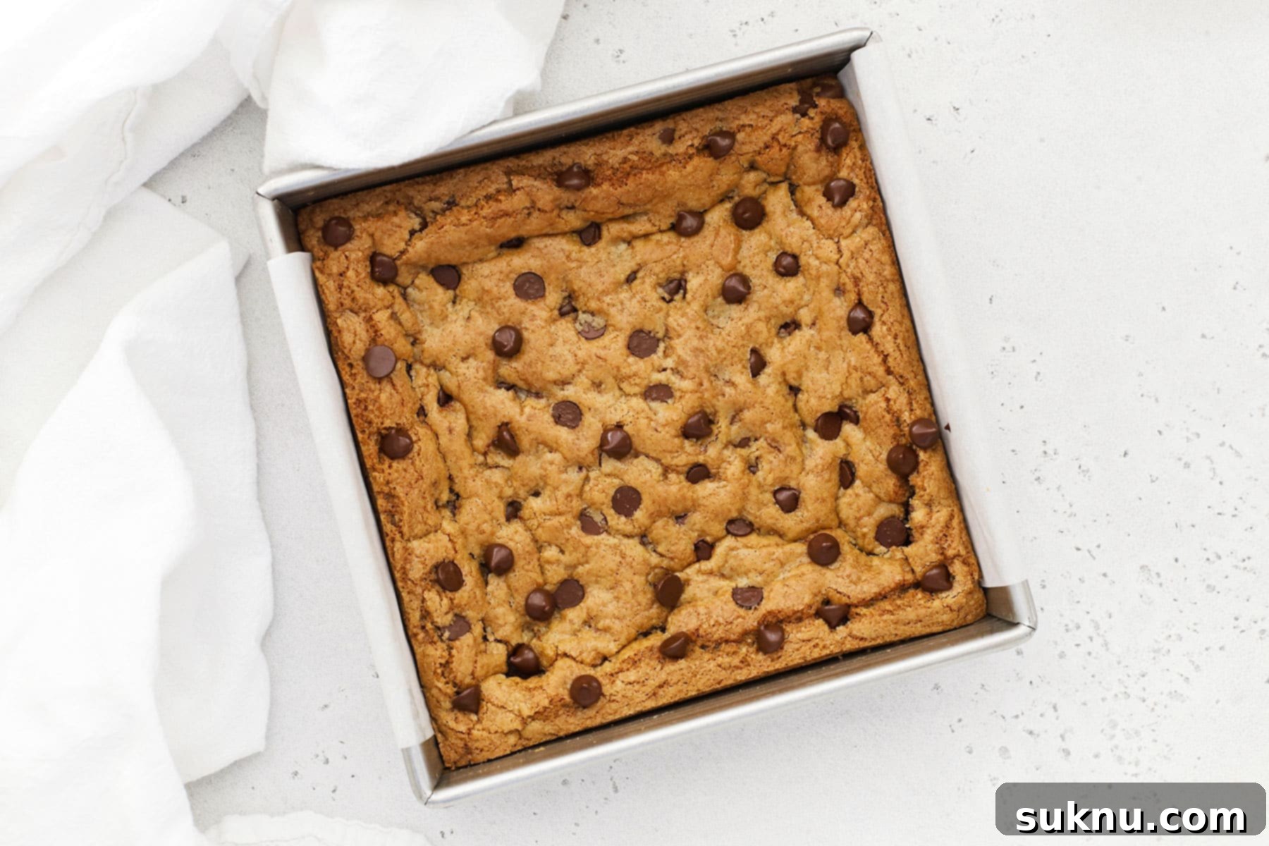 Ultimate Gluten-Free Chocolate Chip Cookie Bars 3 A golden-brown pan of freshly baked gluten-free chocolate chip cookie bars, ready to be cut and enjoyed.