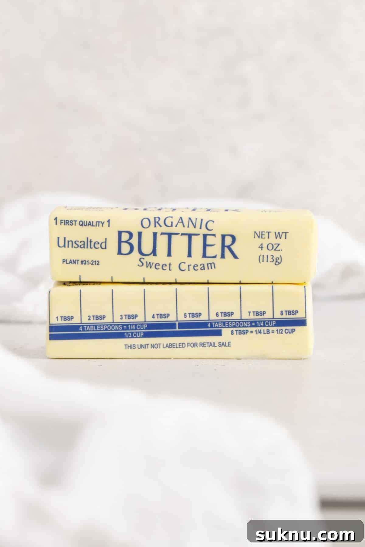 Demystifying Butter Measurement: Sticks, Tablespoons, and More 4 Two sticks of butter stacked, showcasing their uniform size and potential for easy measurement.