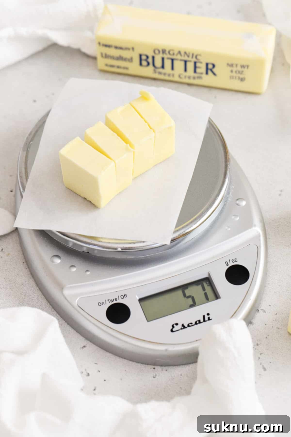 Demystifying Butter Measurement: Sticks, Tablespoons, and More 7 Weighing butter on a digital kitchen scale, demonstrating precise measurement for baking.