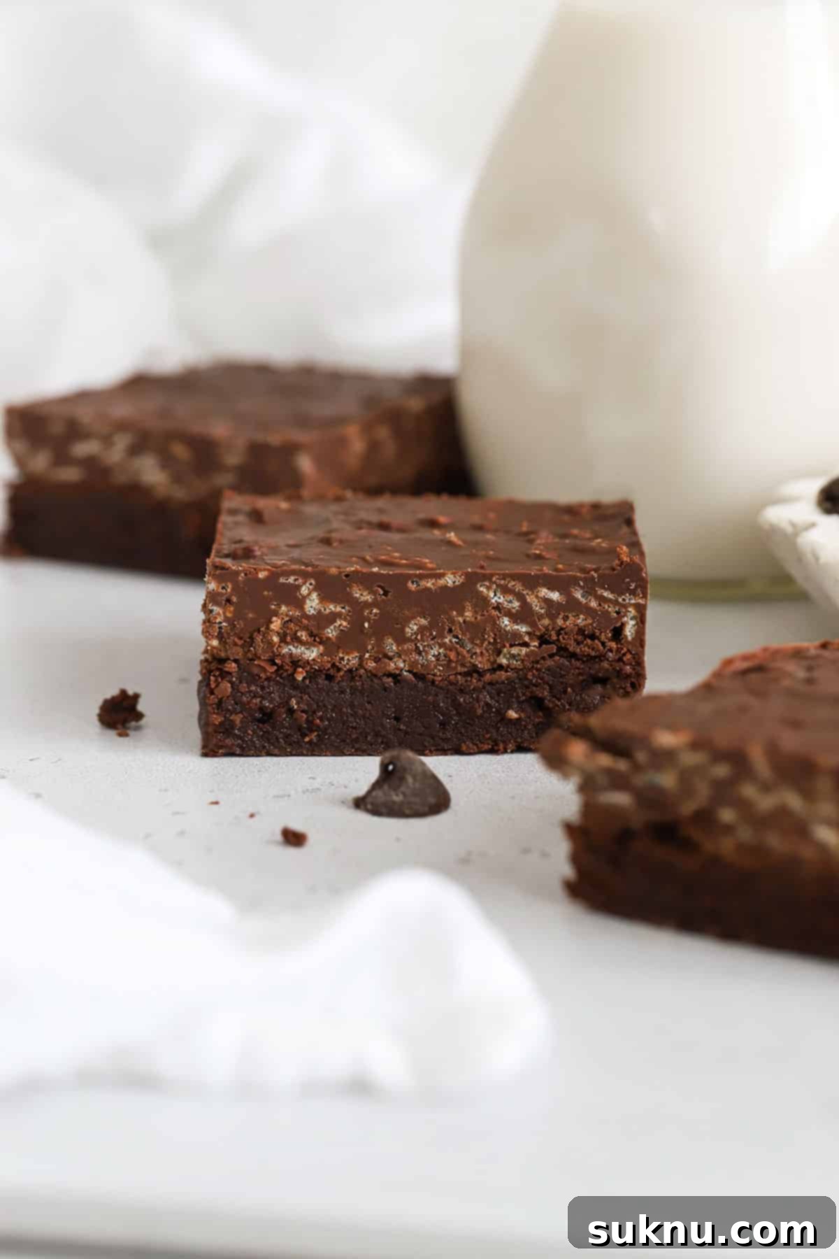 Gluten Free Crunchy Brownies 6 Delicious gluten-free brownies topped with a rich chocolate crisp layer, cut into squares and stacked.