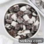 a bowl of cookies and cream muddy buddies with chopped gluten-free oreos