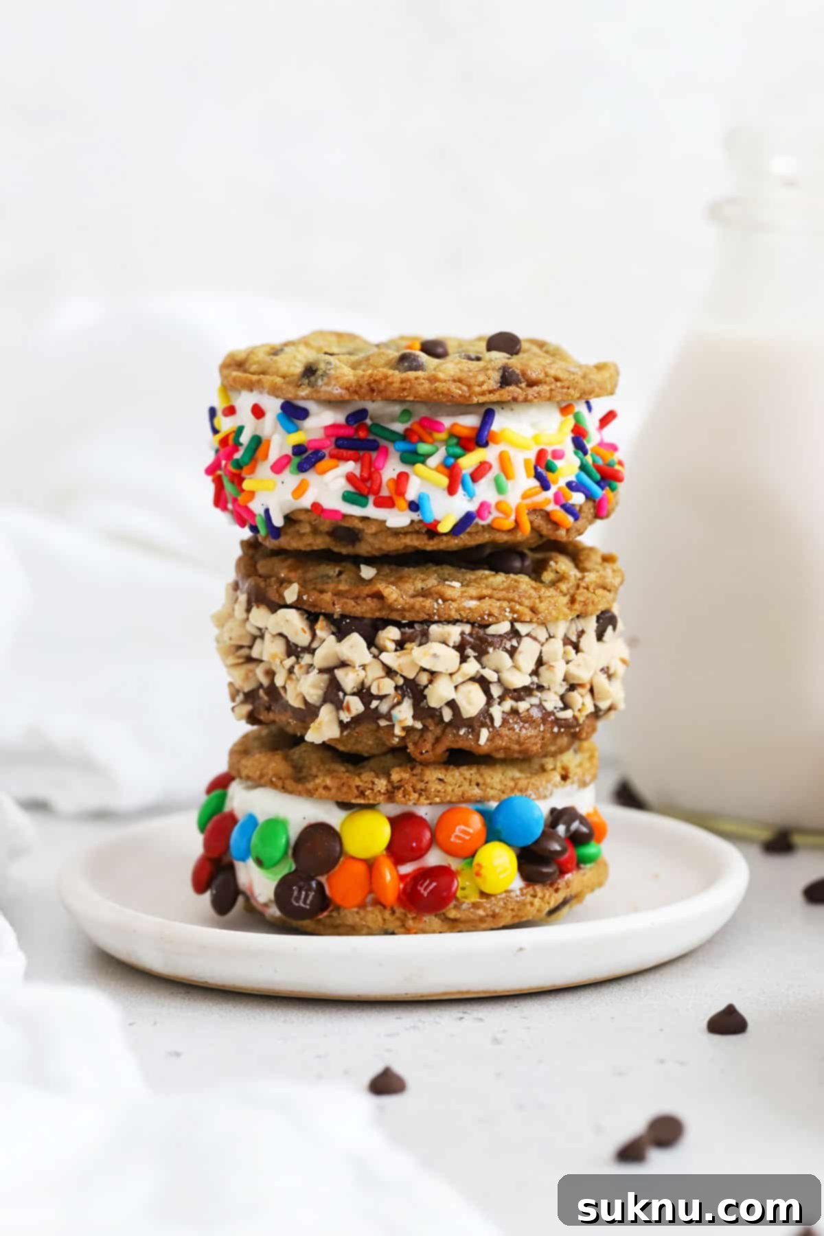 Two gluten-free cookie ice cream sandwiches stacked elegantly on a white plate, ready for serving.
