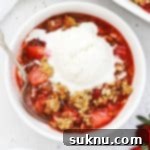 Gluten Free Strawberry Crumble 11 gluten free strawberry crisp in a white bowl topped with vanilla ice cream