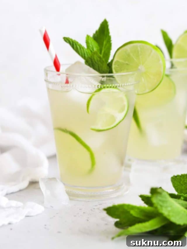 Front view of two glasses of virgin mojito mint limeade, a non-alcoholic refreshing drink.