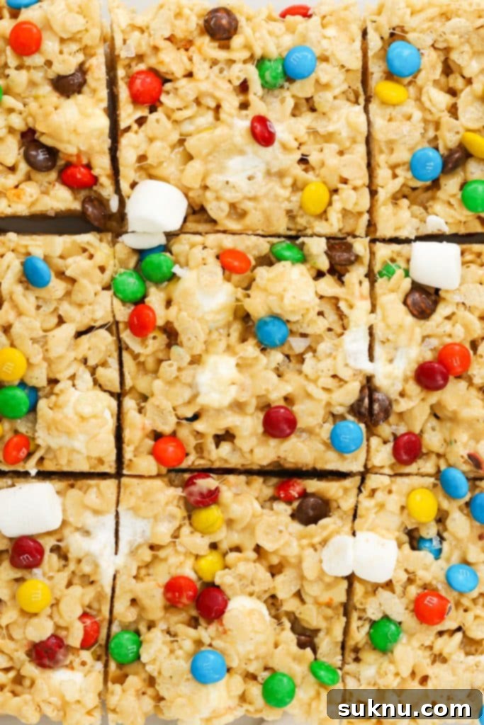 Gluten-free M&M rice krispie treats cut into perfect squares, colorful and chewy