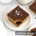 Gluten-free chocolate peanut butter bars stacked on a white plate