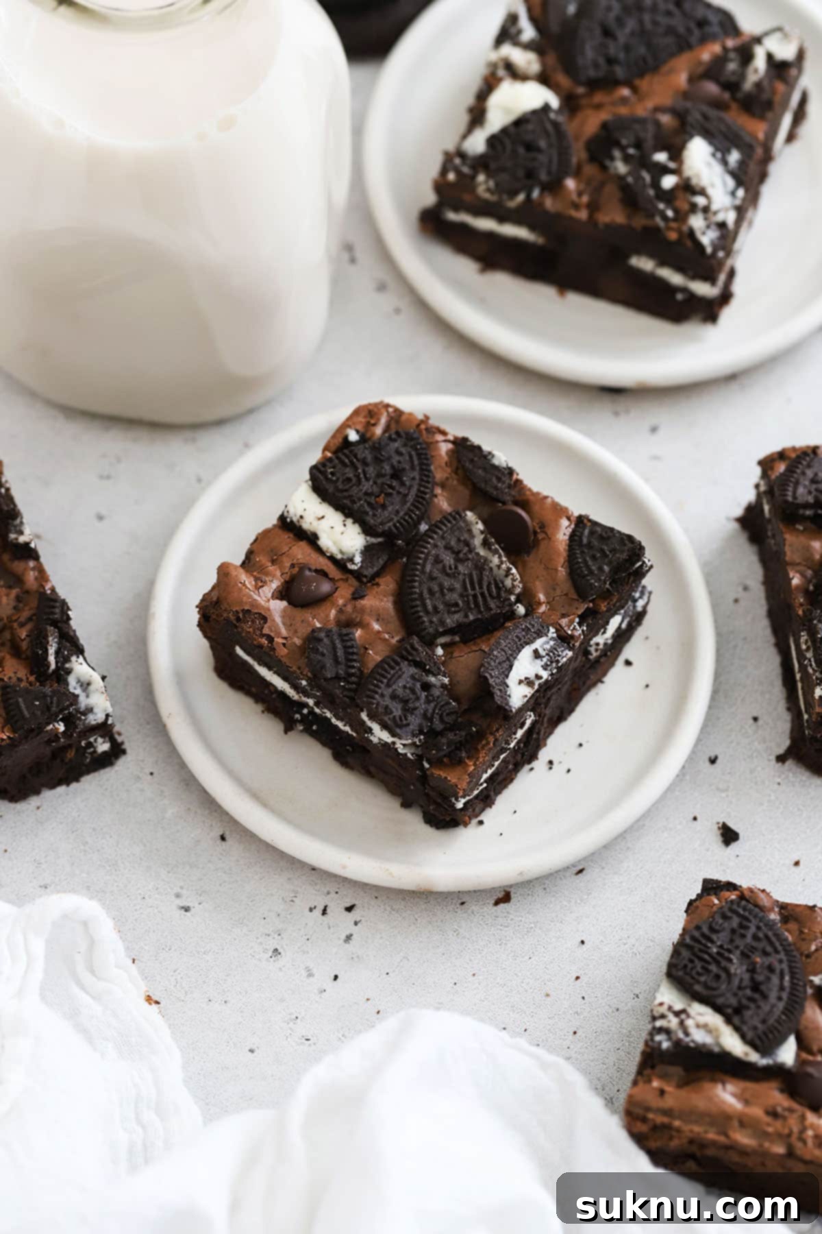 Gluten-free Oreo brownie squares arranged attractively on a white background, highlighting their delicious appearance.