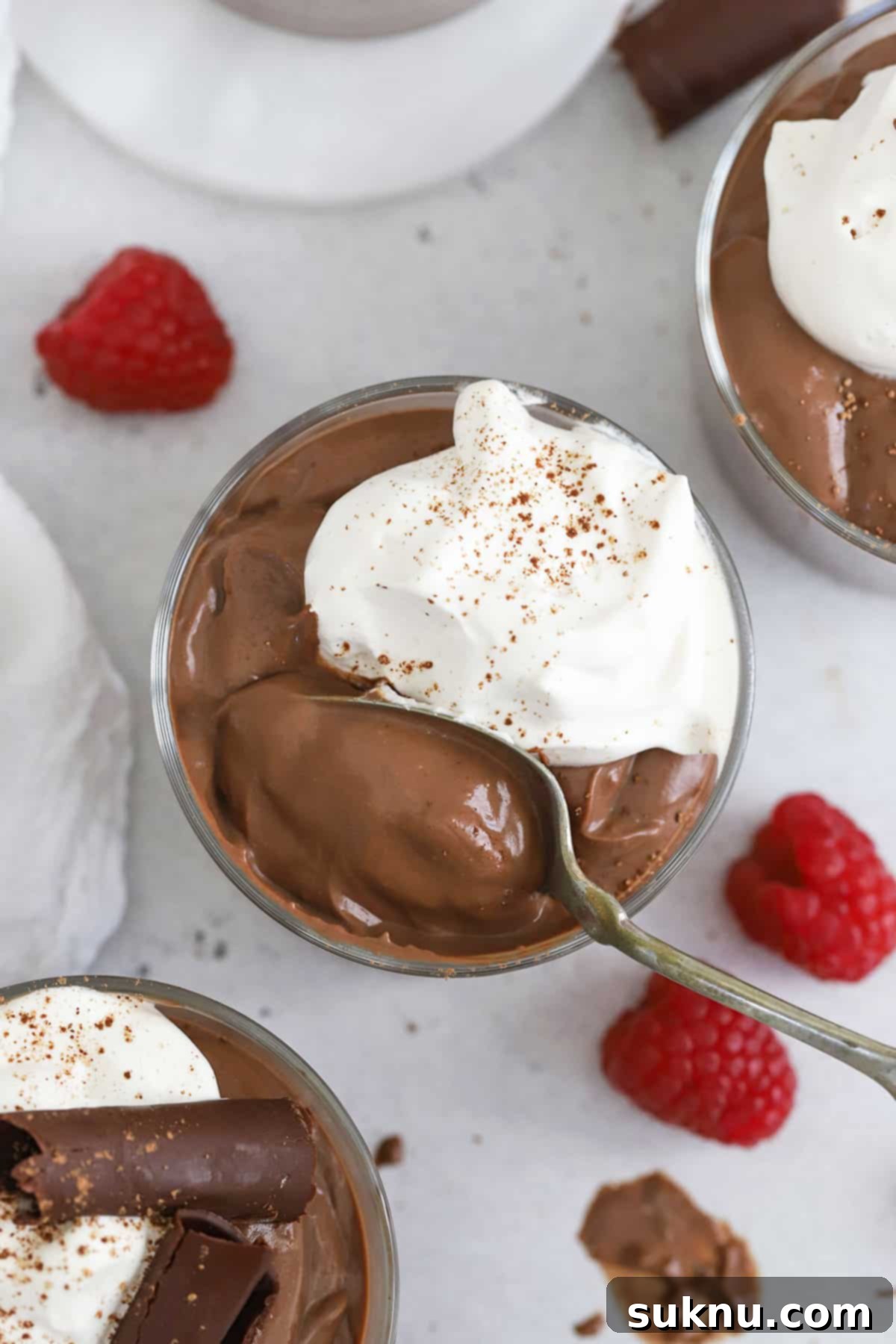 glass bowls of gluten-free chocolate pudding topped with whipped cream