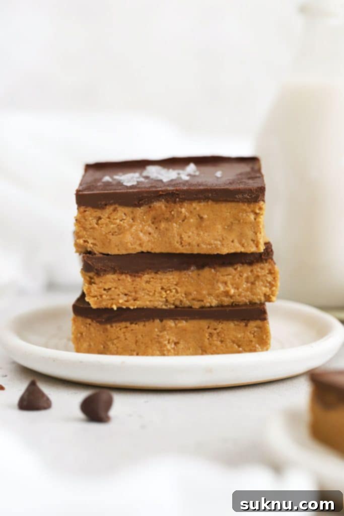 gluten-free chocolate peanut butter bars stacked on a white plate