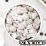 Gluten-free muddy buddies in a white bowl, ready to be served and enjoyed as a delicious no-bake treat.