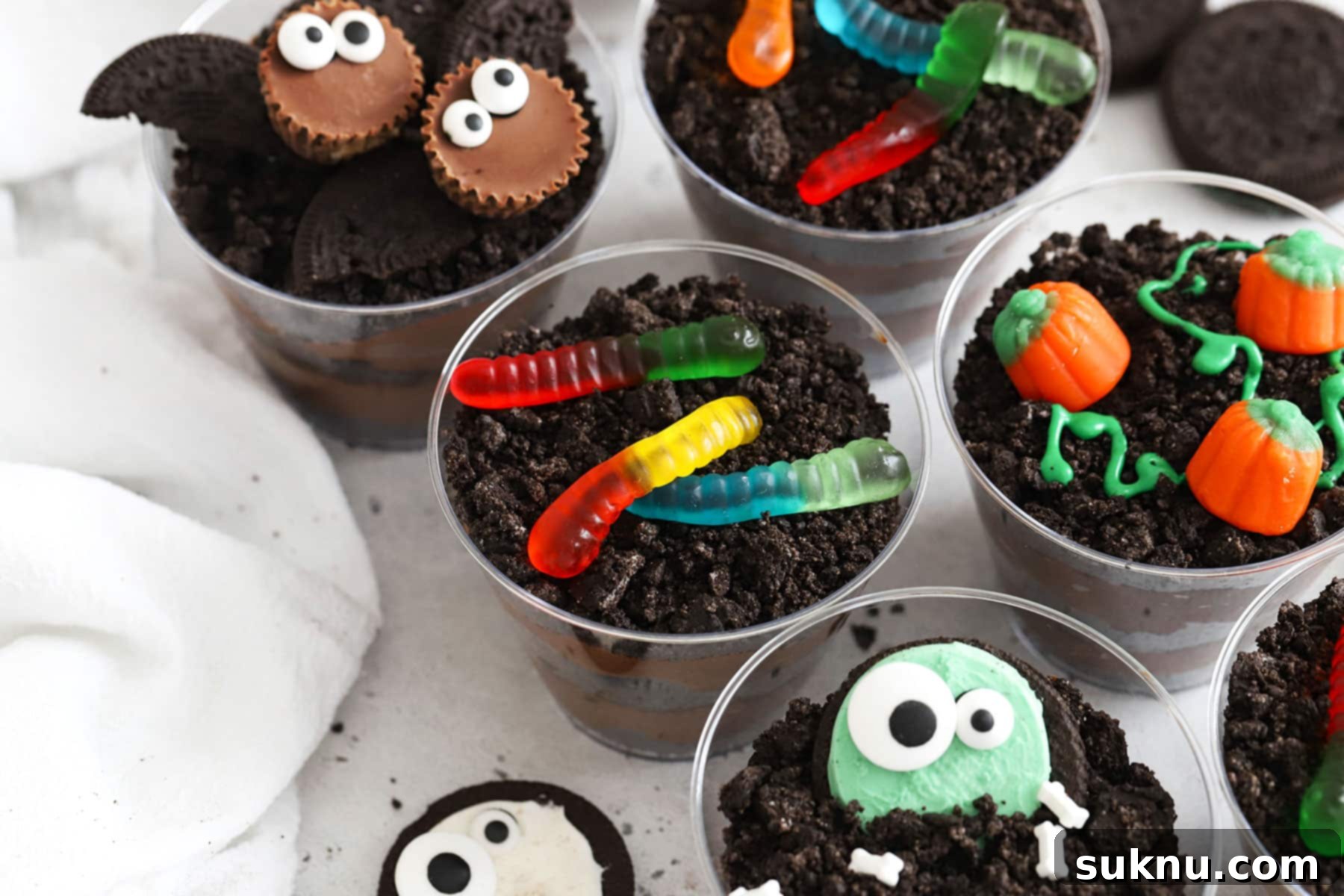 Gluten-free Halloween dirt pudding decorated to look like bats, monsters, pumpkins, and more