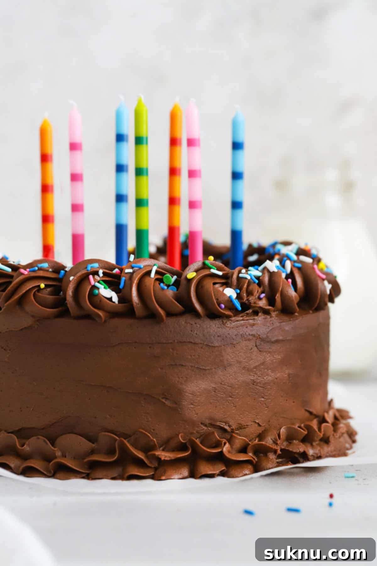 Classic Gluten-Free Yellow Birthday Cake 6 Gluten-free vanilla cake with chocolate frosting, colorful sprinkles, and colorful striped birthday candles