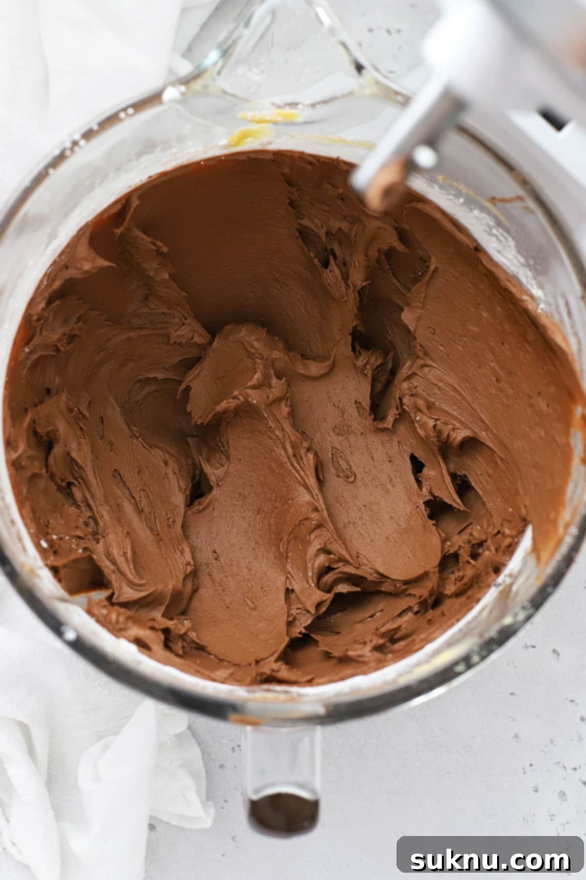 Decadent Gluten-Free Chocolate Buttercream 5 freshly mixed chocolate buttercream frosting in a glass mixing bowl
