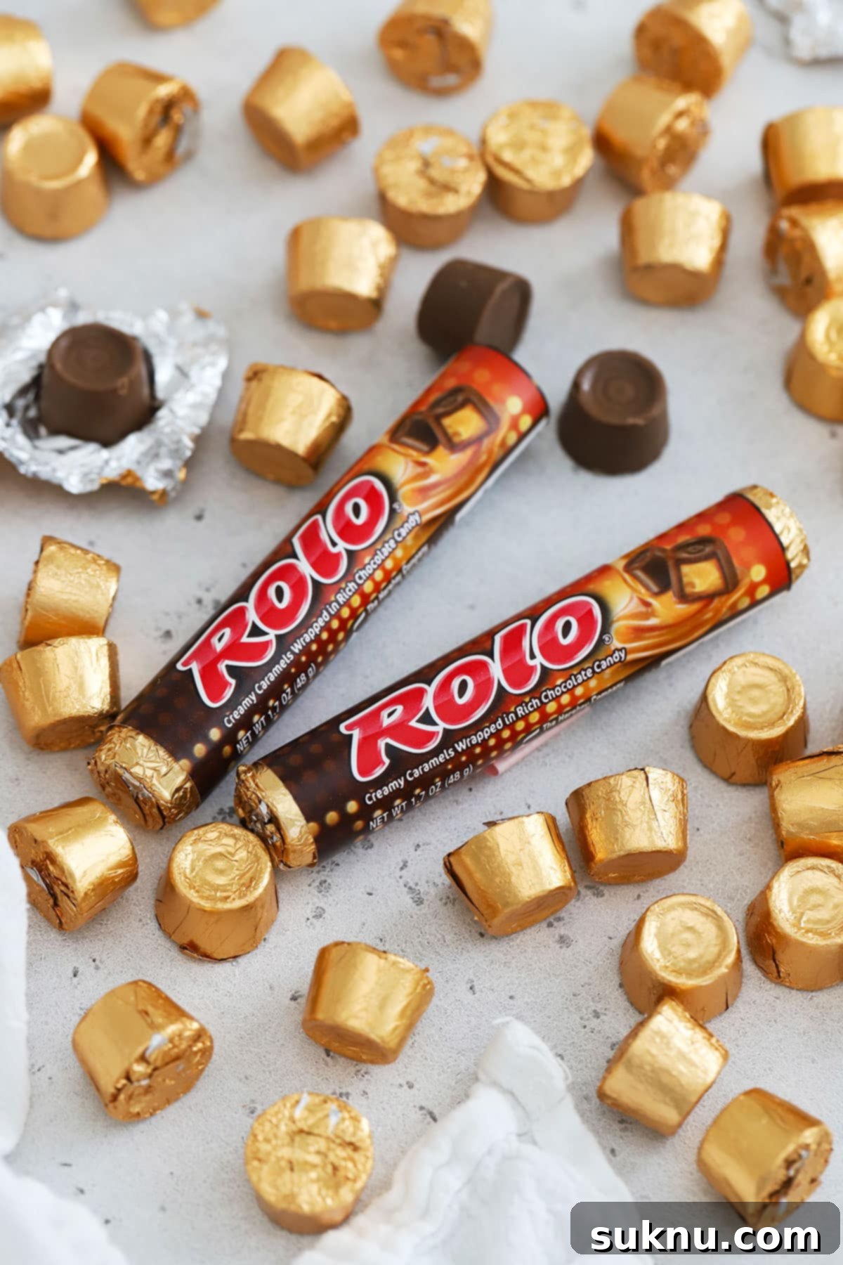 two packages of rolos on a white background with more rolo candy