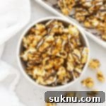 Swirled Zebra Popcorn 11 white bowl filled with zebra popcorn drizzled with white chocolate and dark chocolate