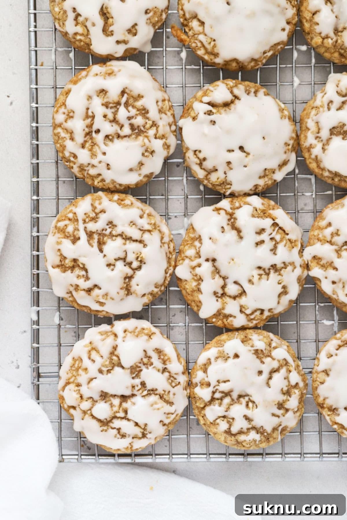 Gluten-Free Iced Oatmeal Cookies on a cooling rack, perfectly glazed and spiced