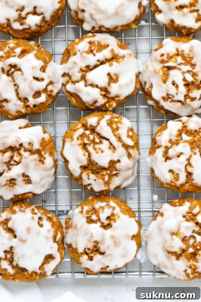 gluten-free pumpkin oatmeal cookies with vanilla glaze on a wire rack