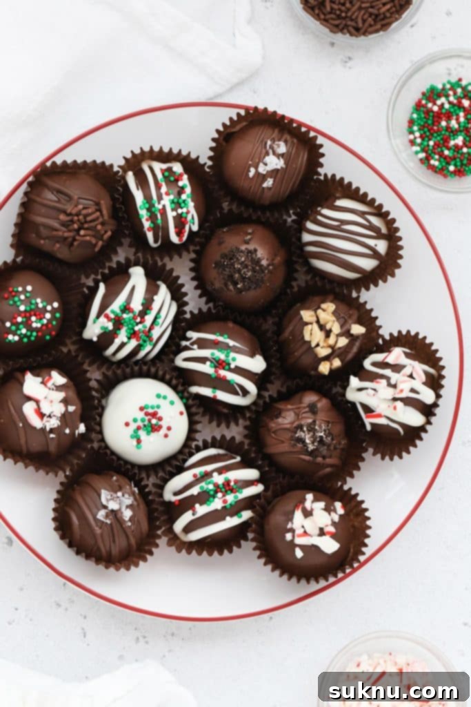 Gluten-Free Rolo Pretzel Turtles 10 Gluten-free Oreo truffles, elegantly decorated with diverse toppings, arranged on a charming white plate with a red rim.