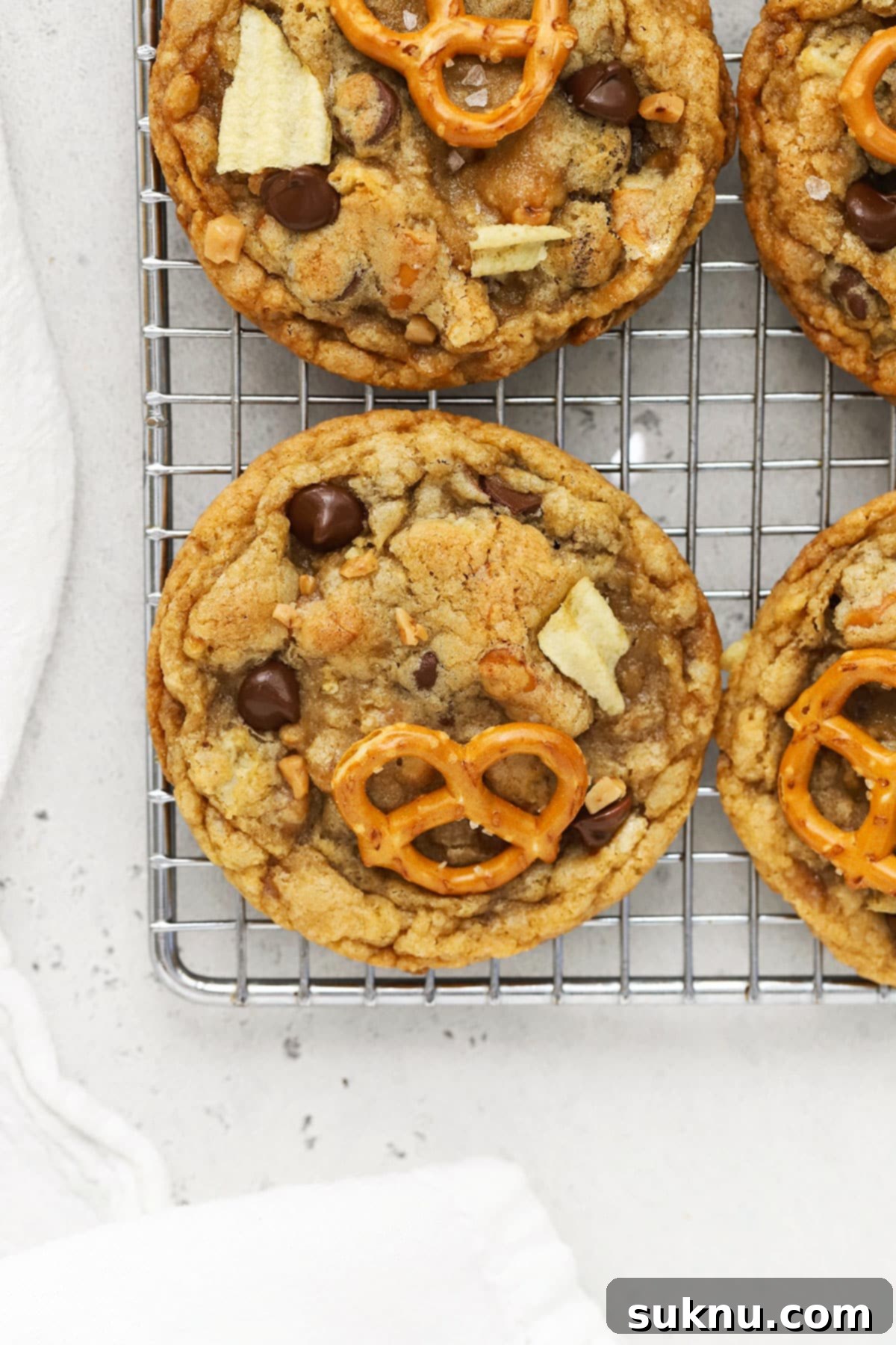 Gluten Free Everything Cookies 2 gluten-free kitchen sink cookies on a wire cooling rack