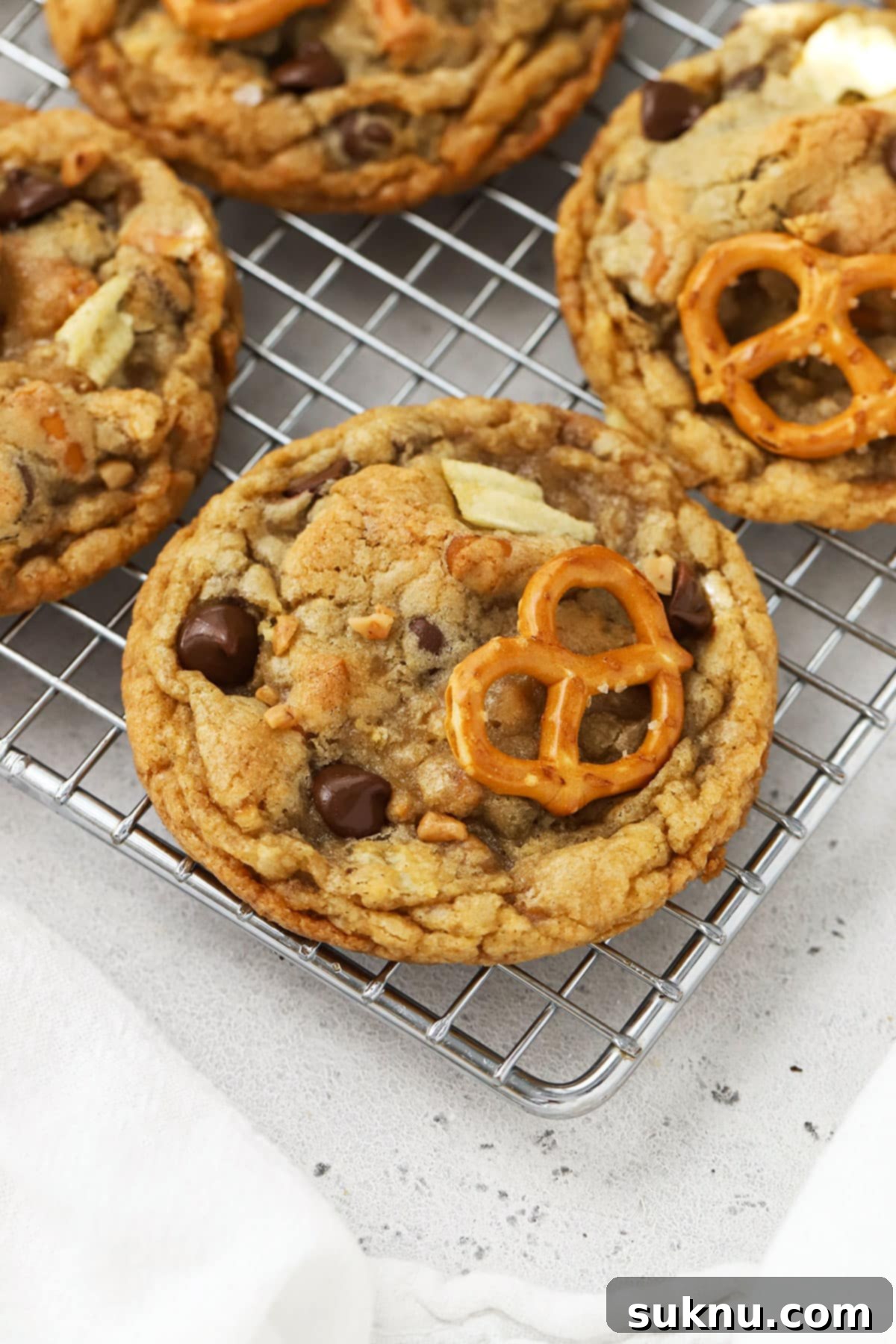 Gluten Free Everything Cookies 5 gluten-free kitchen sink cookies on a wire cooling rack