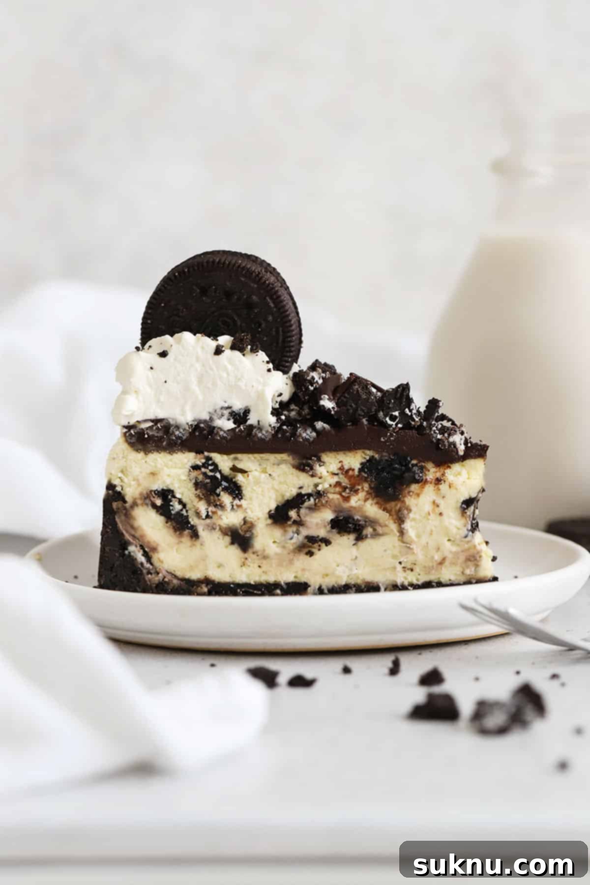 Ultimate Gluten-Free Oreo Cheesecake 9 slice of gluten-free Oreo cheesecake topped with chocolate ganache, chopped Oreo cookies, and whipped cream