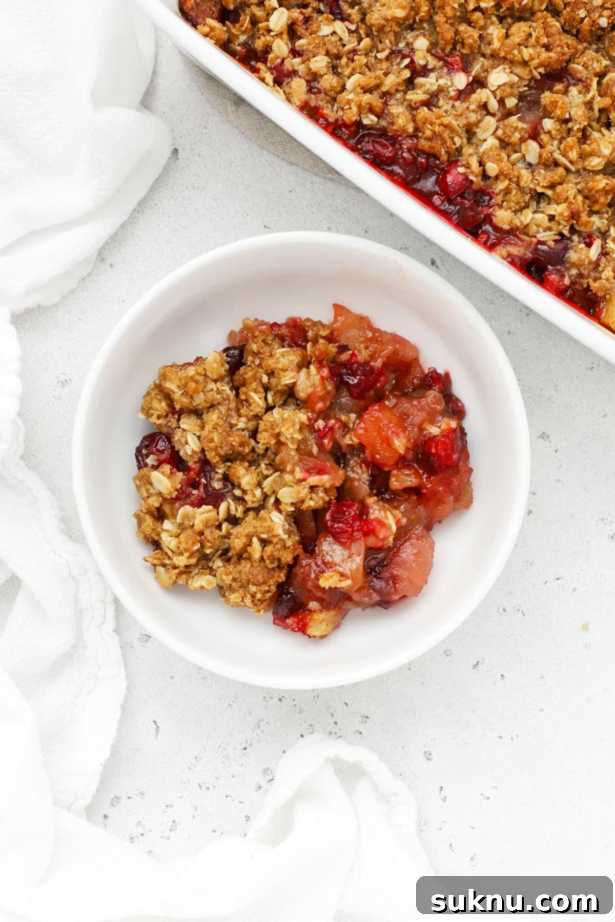 gluten-free cranberry crisp scooped into a white dessert bowl