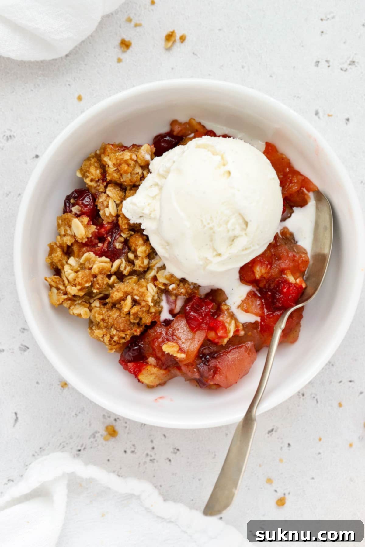 gluten-free cranberry crisp with a scoop of vanilla ice cream on top