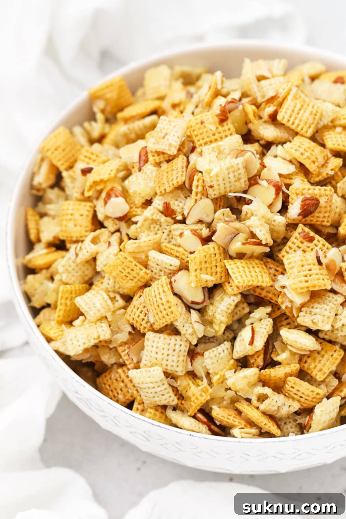 white serving bowl with gluten-free sticky chex mix