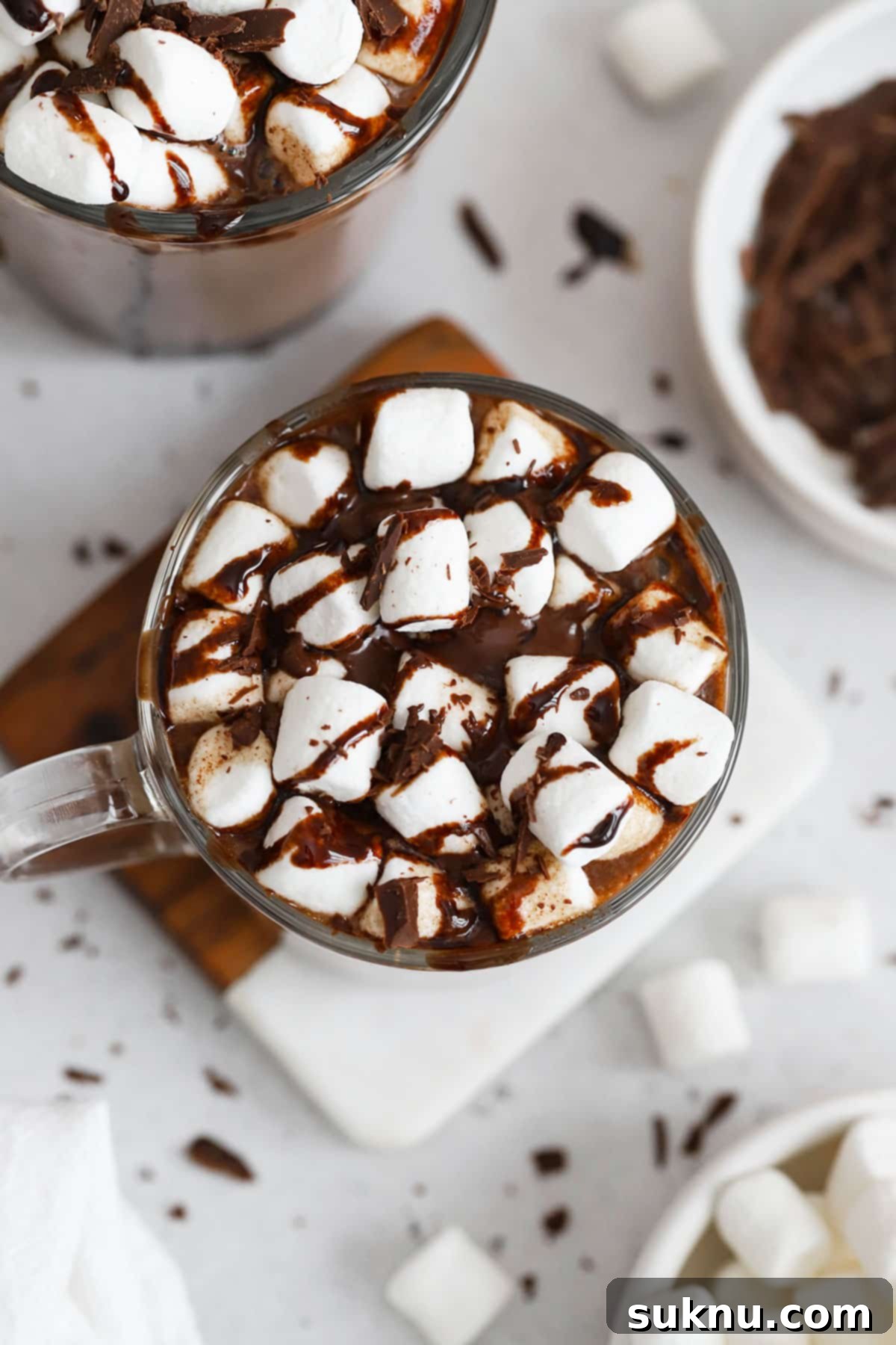homemade hot chocolate topped with marshmallows and chocolate syrup