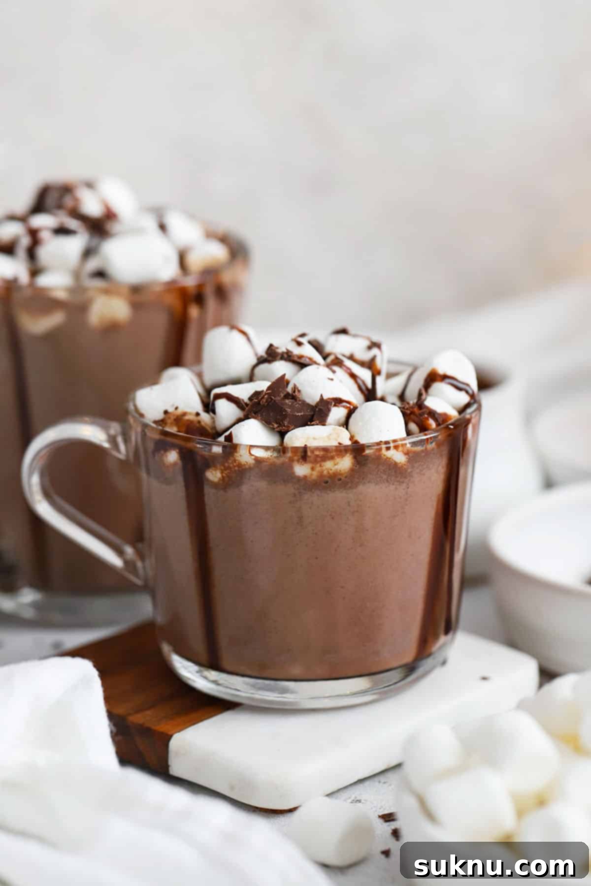 homemade hot chocolate topped with marshmallows and chocolate syrup