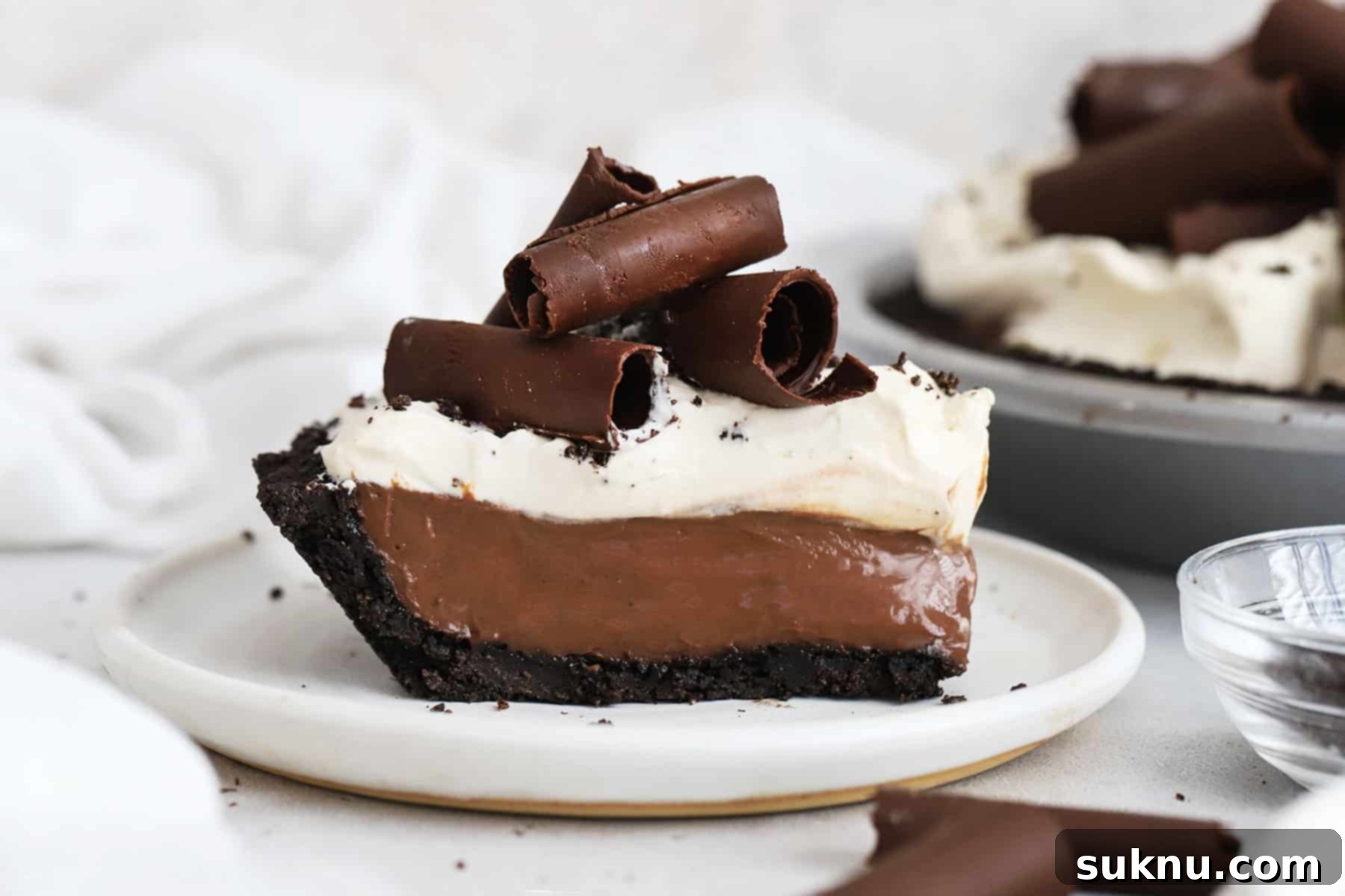 Decadent Gluten-Free Chocolate Pie 12 a slice of gluten-free chocolate cream pie topped with whipped cream and chocolate curls