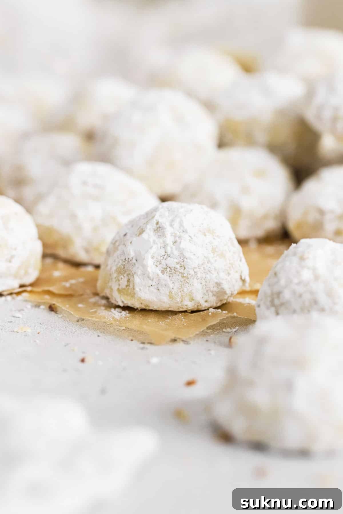 Gluten-Free Snowball Cookies 6 gluten-free mexican wedding cookies on parchment paper
