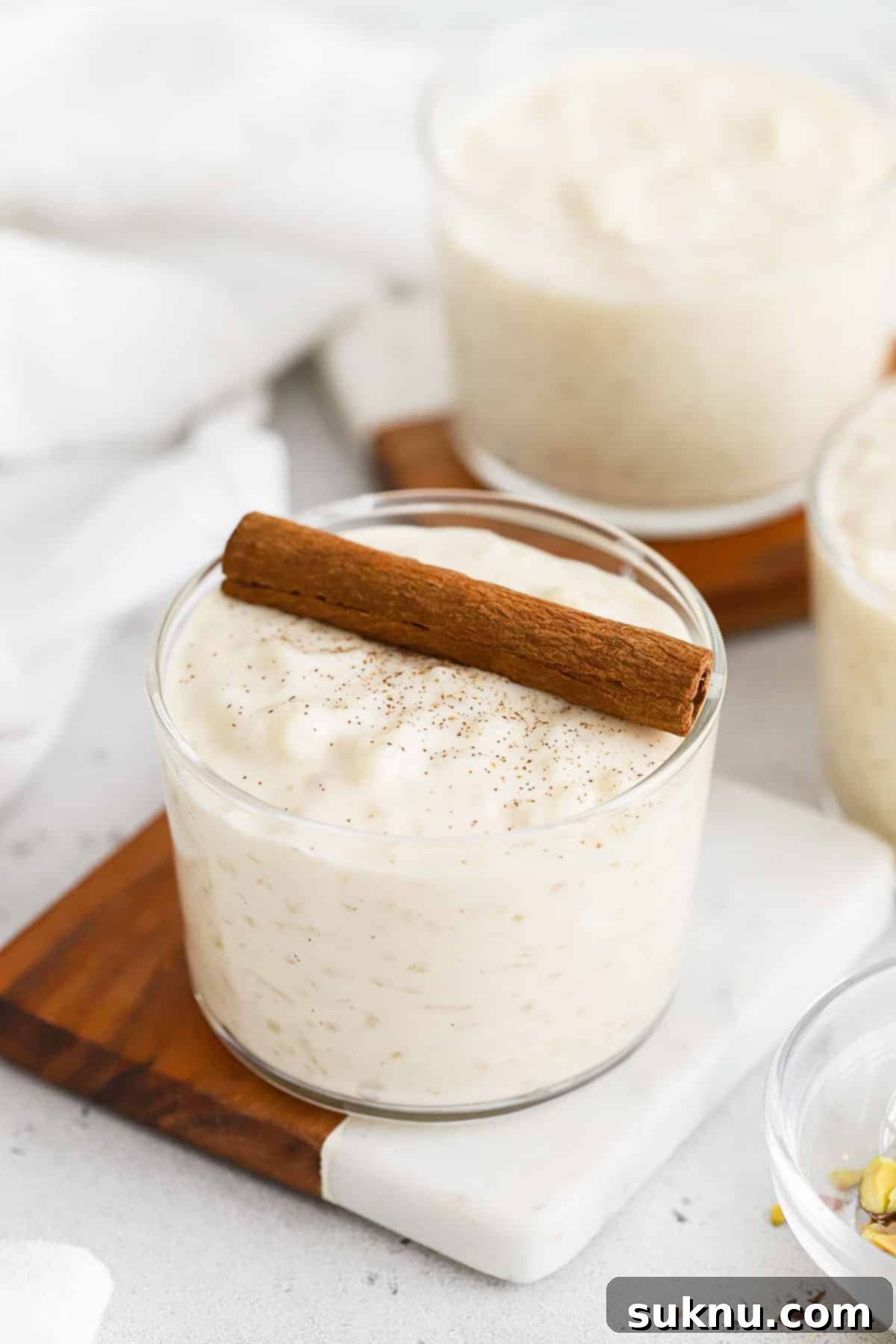 Velvety Gluten-Free Rice Pudding 7 glass bowls of gluten-free rice pudding topped with cinnamon sticks