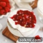 Danish rice pudding in dessert bowls topped with raspberry sauce