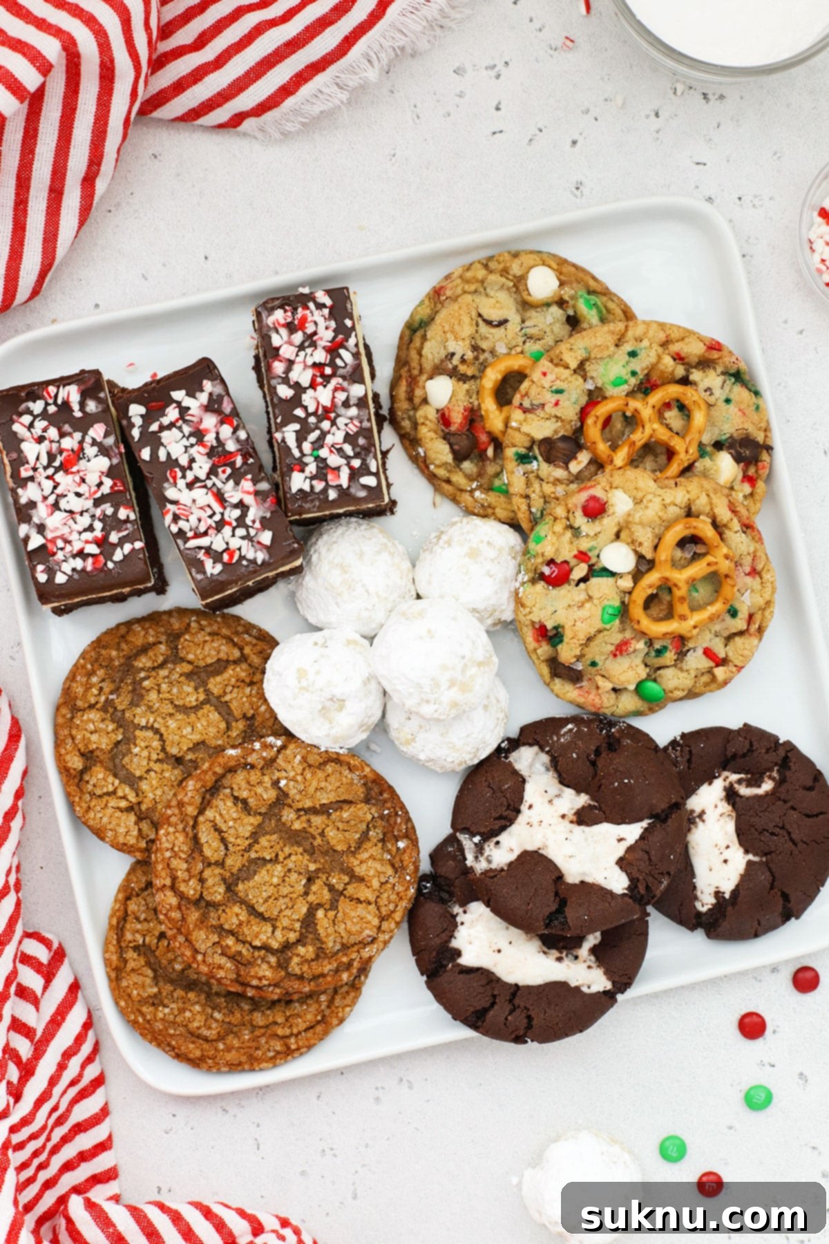 5 kinds of gluten-free holiday cookies on a white platter, featuring a variety of textures and festive decorations.