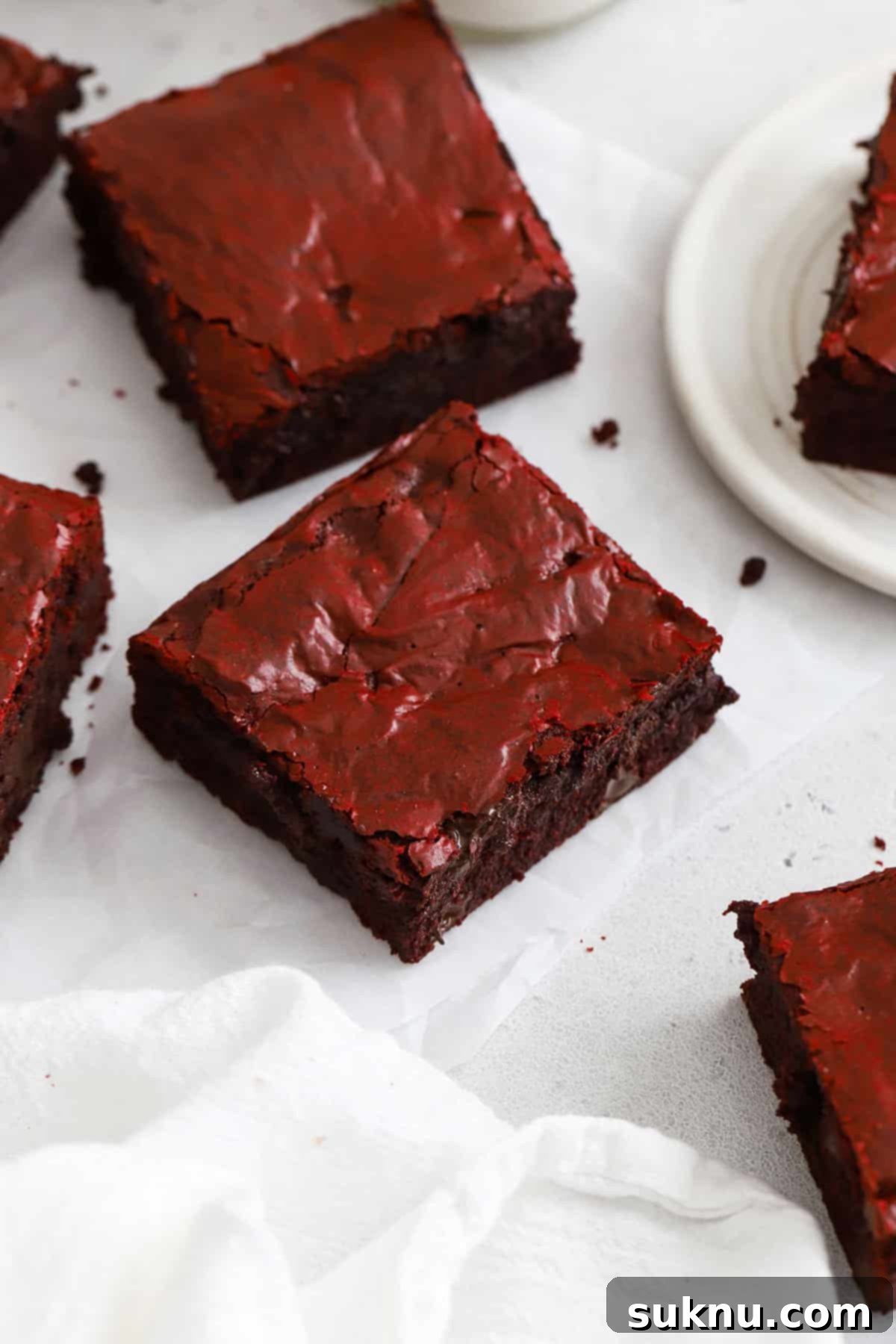 Gluten-free red velvet brownies cut into perfect squares, showcasing their vibrant color and fudgy texture.