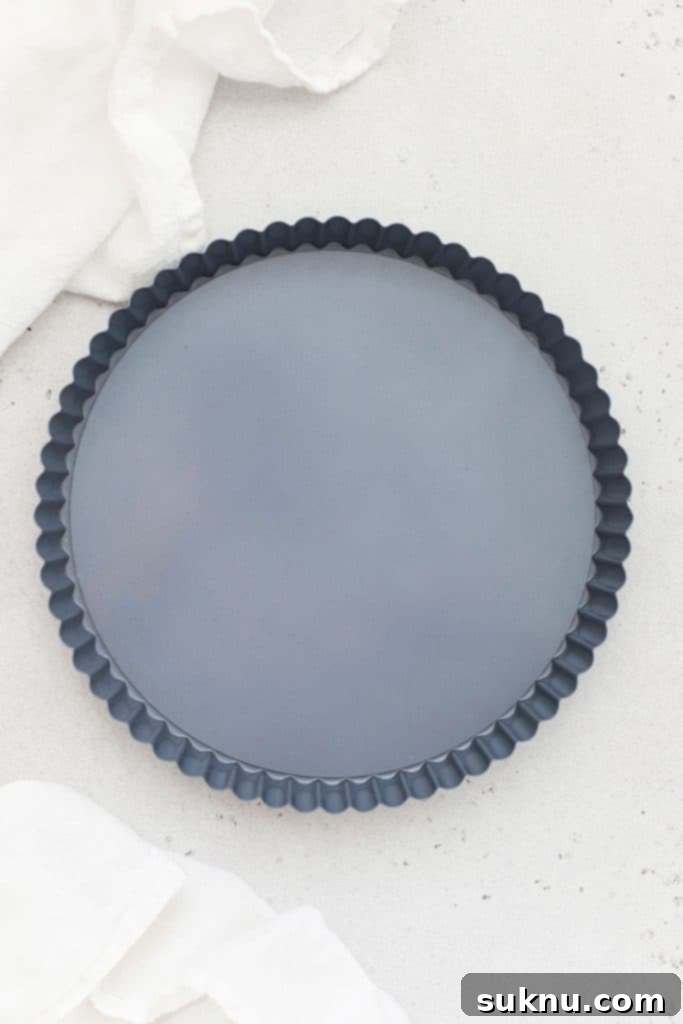 A nine-inch tart pan with a removable bottom, essential for achieving the classic tart shape and easy serving.