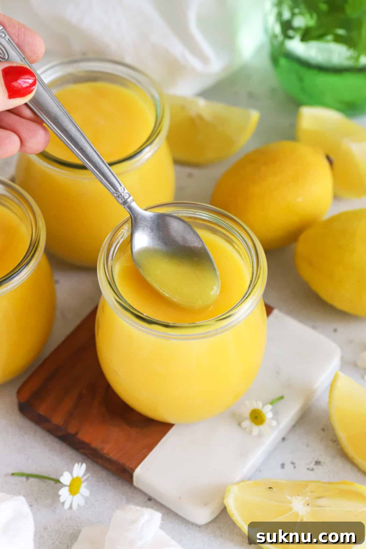 Simple Scratch-Made Lemon Curd 8 a spoon scooping homemade lemon curd from a jar