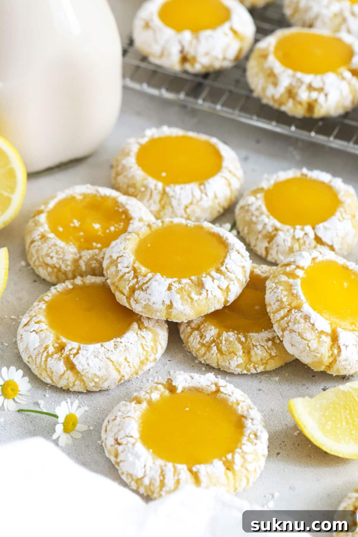 Zesty Gluten-Free Lemon Curd Gems 7 A beautifully arranged stack of gluten-free lemon thumbprint cookies on a white background, highlighting their crinkled tops and lemon curd centers.